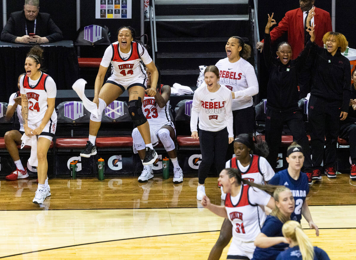 UNLV Lady Rebels players, including forward Alyssa Brown (44) center Desi-Rae Young (23) react ...