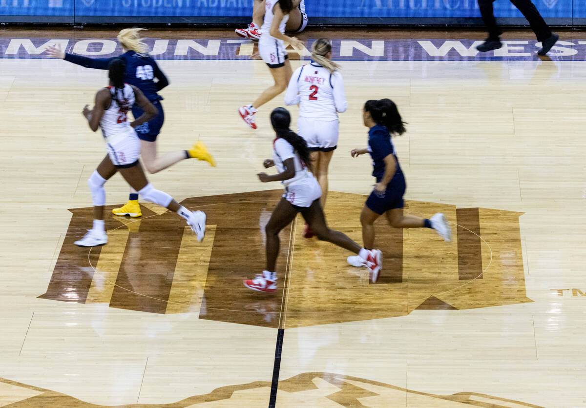 UNLV Lady Rebels players and Nevada Wolf Pack run the court during the Mountain West tournament ...
