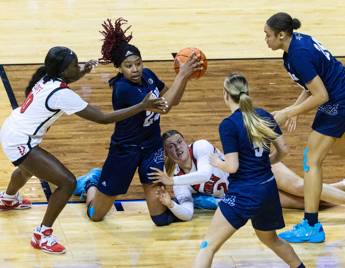Nevada Wolf Pack forward Lexie Givens (23) fights for the loose ball against UNLV Lady Rebels g ...
