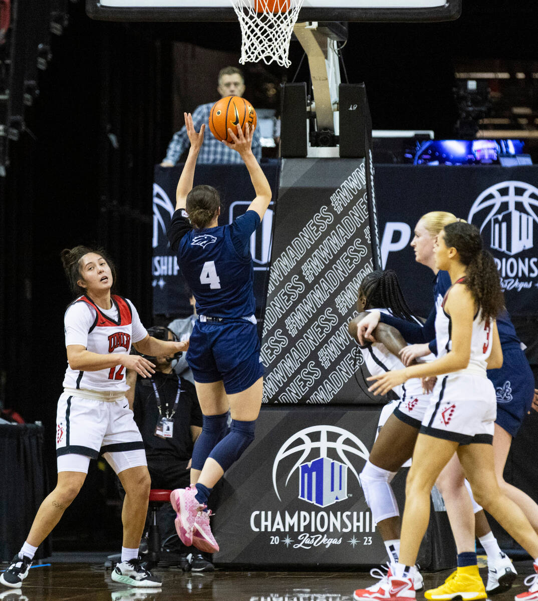 Nevada Wolf Pack guard Audrey Roden (4) shoots for the basket as UNLV Lady Rebels guard Alyssa ...