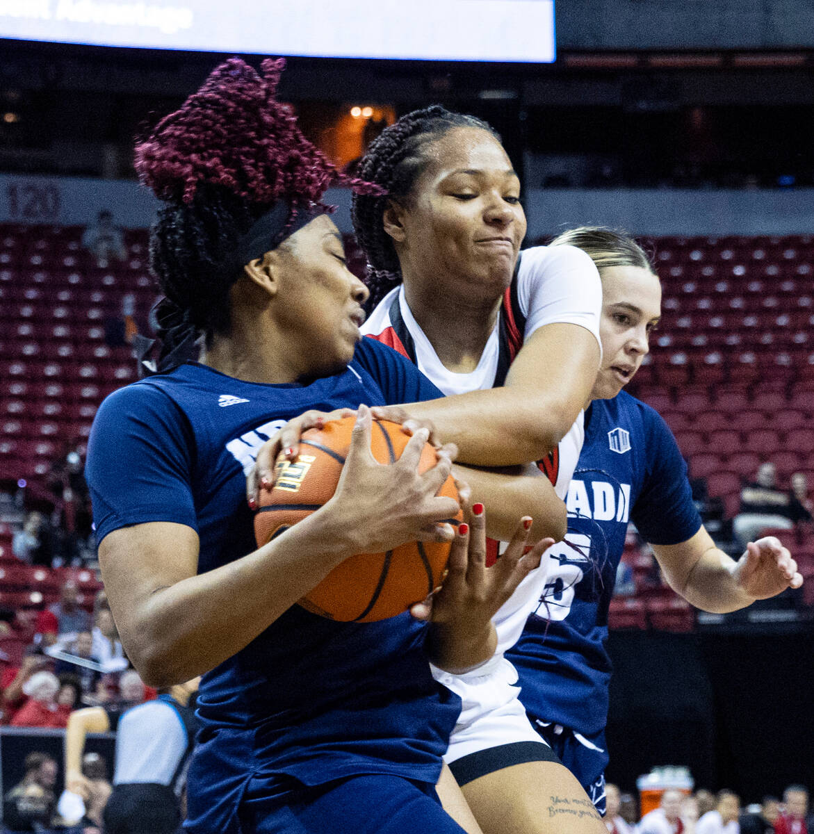 Nevada Wolf Pack forward Lexie Givens (23) fights for the ball against UNLV Lady Rebels forwar ...