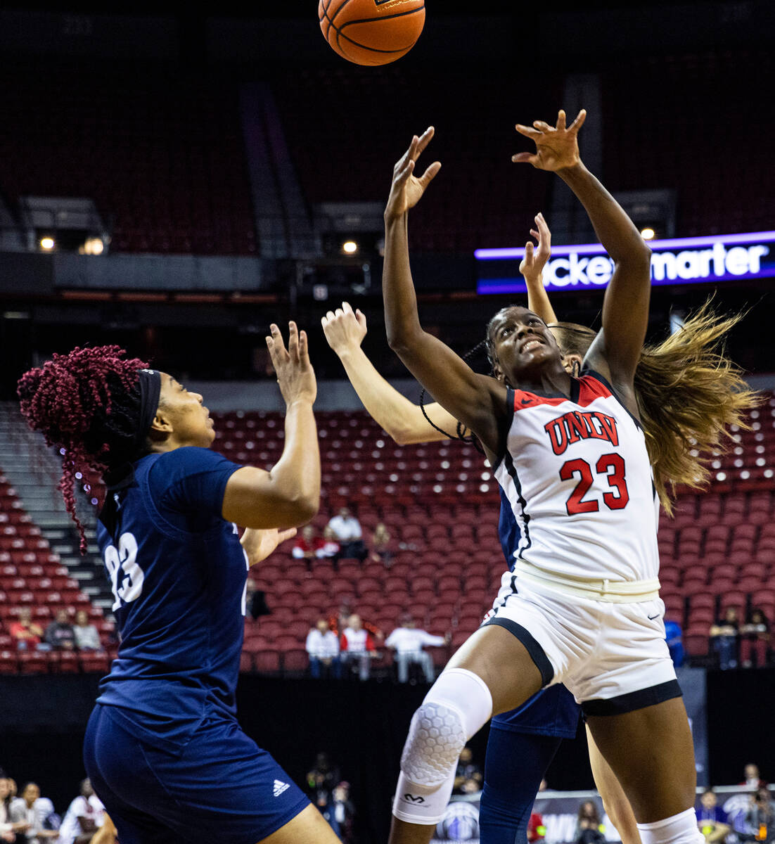 UNLV Lady Rebels center Desi-Rae Young (23) goes for a rebound against Nevada Wolf Pack forward ...