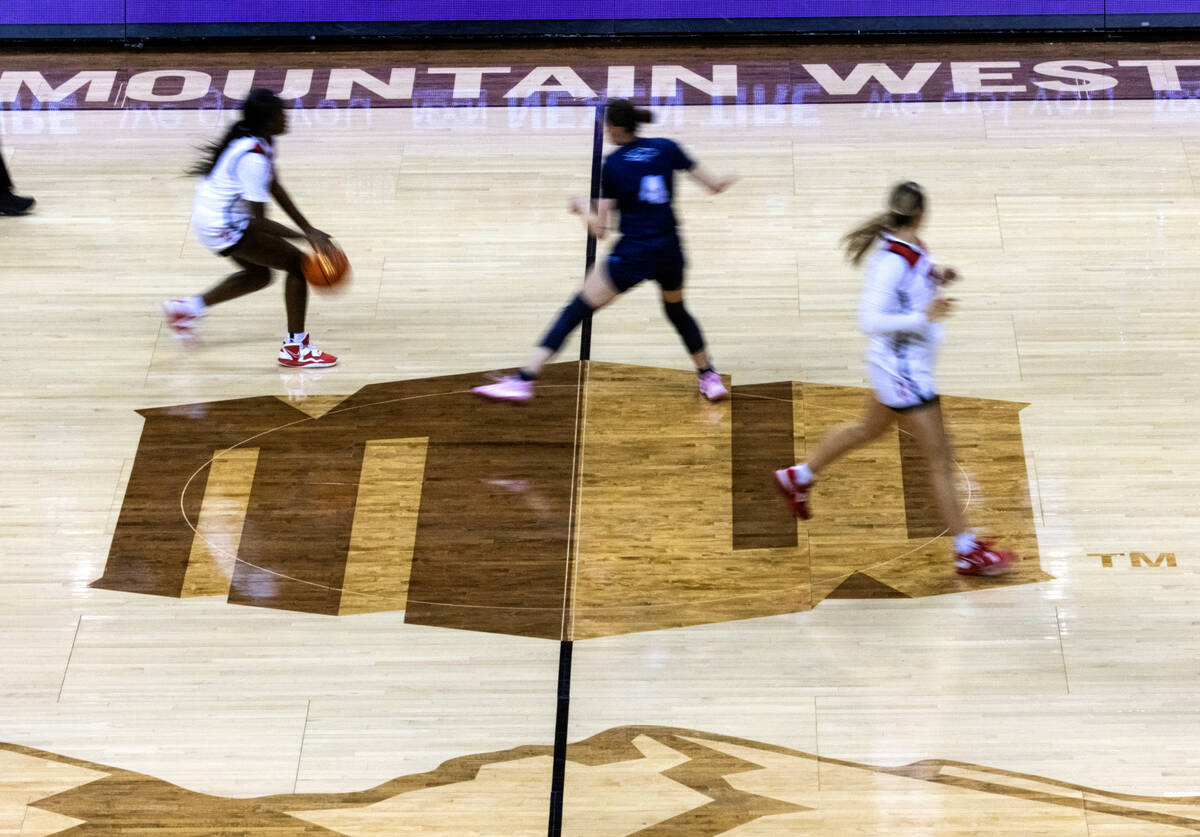 UNLV Lady Rebels players and Nevada Wolf Pack run the court during the Mountain West tournament ...