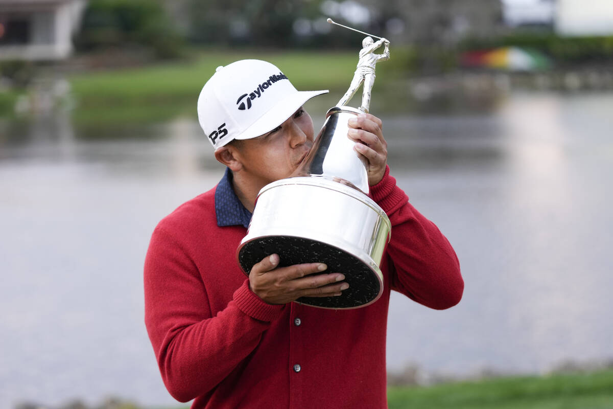 Kurt Kitayama kisses the championship trophy after winning the Arnold Palmer Invitational golf ...