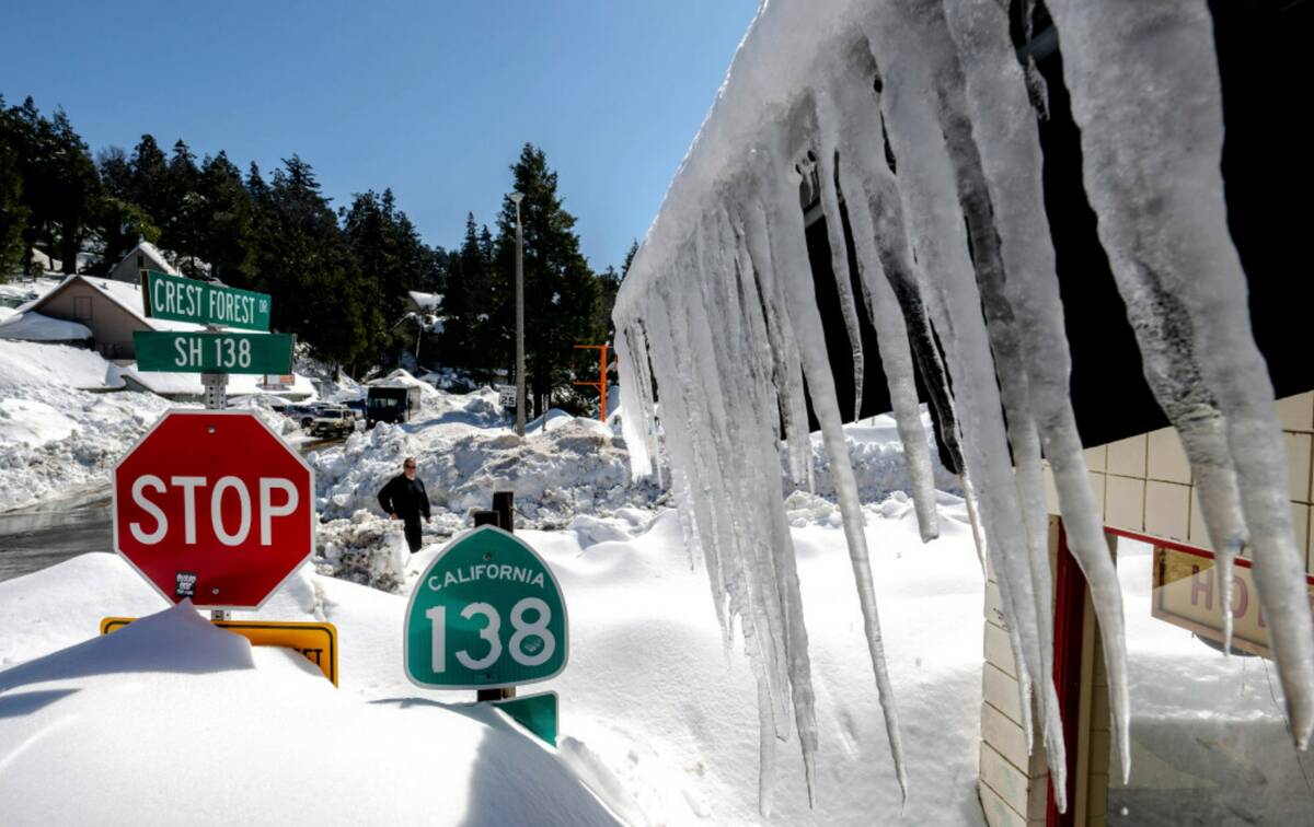 Snowfall surrounds businesses in Crestline, Calif., Friday, March 3, 2023, following a huge sno ...