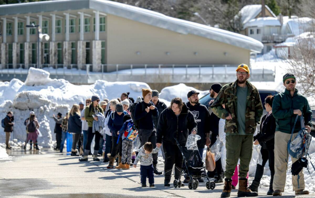 Residents in San Bernardino Mountain brave long lines for food at Goodwin & Son's Market in Cre ...