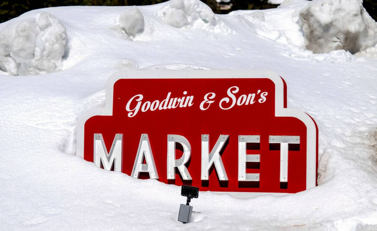The Goodwin & Son's Market sign is buried in feet of snow in Crestline, Calif., Friday, March 3 ...