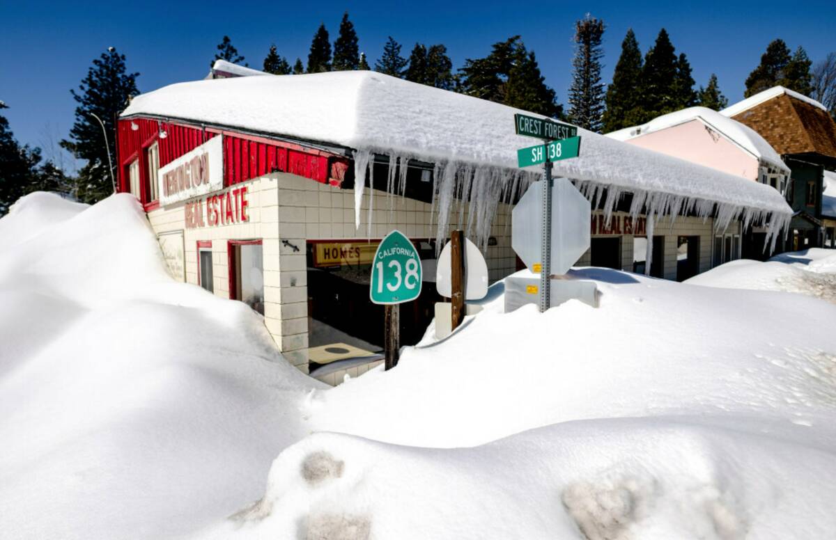 Snowfall surrounds businesses in Crestline, Calif., Friday, March 3, 2023. (Watchara Phomicinda ...