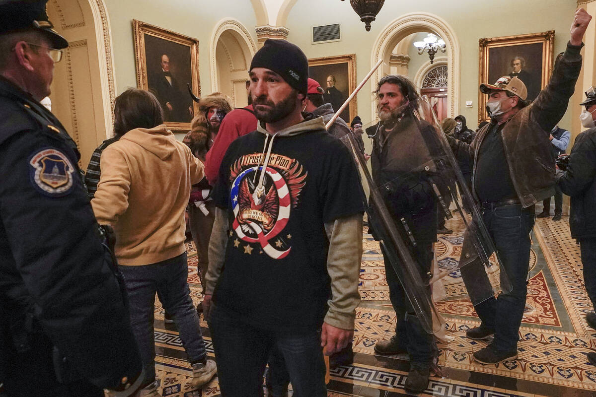 Rioters are confronted by U.S. Capitol Police officers outside the Senate Chamber inside the Ca ...