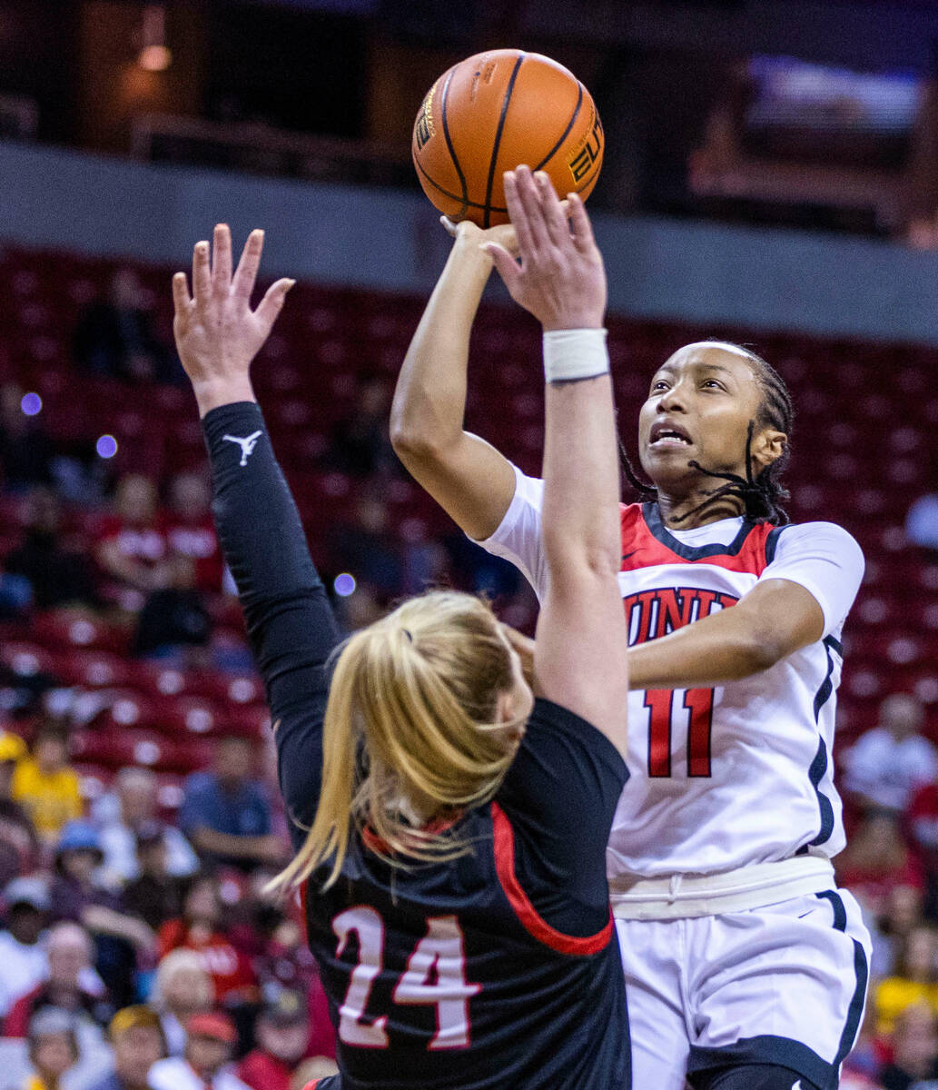 UNLV guard Justice Ethridge (11) elevates for a shot over San Diego State guard Abby Prohaska ( ...