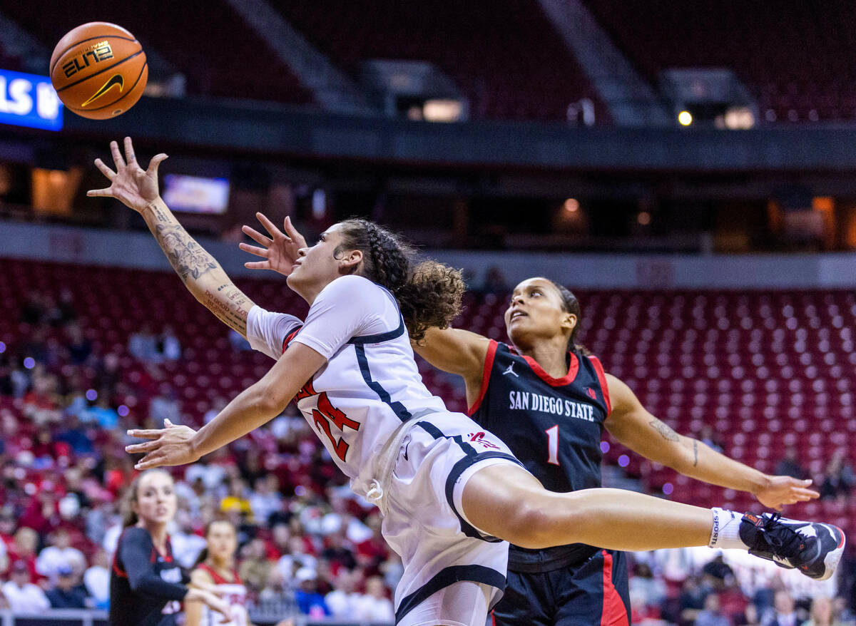 UNLV guard Essence Booker (24) gets inside of San Diego State guard Asia Avinger (1) for a bask ...
