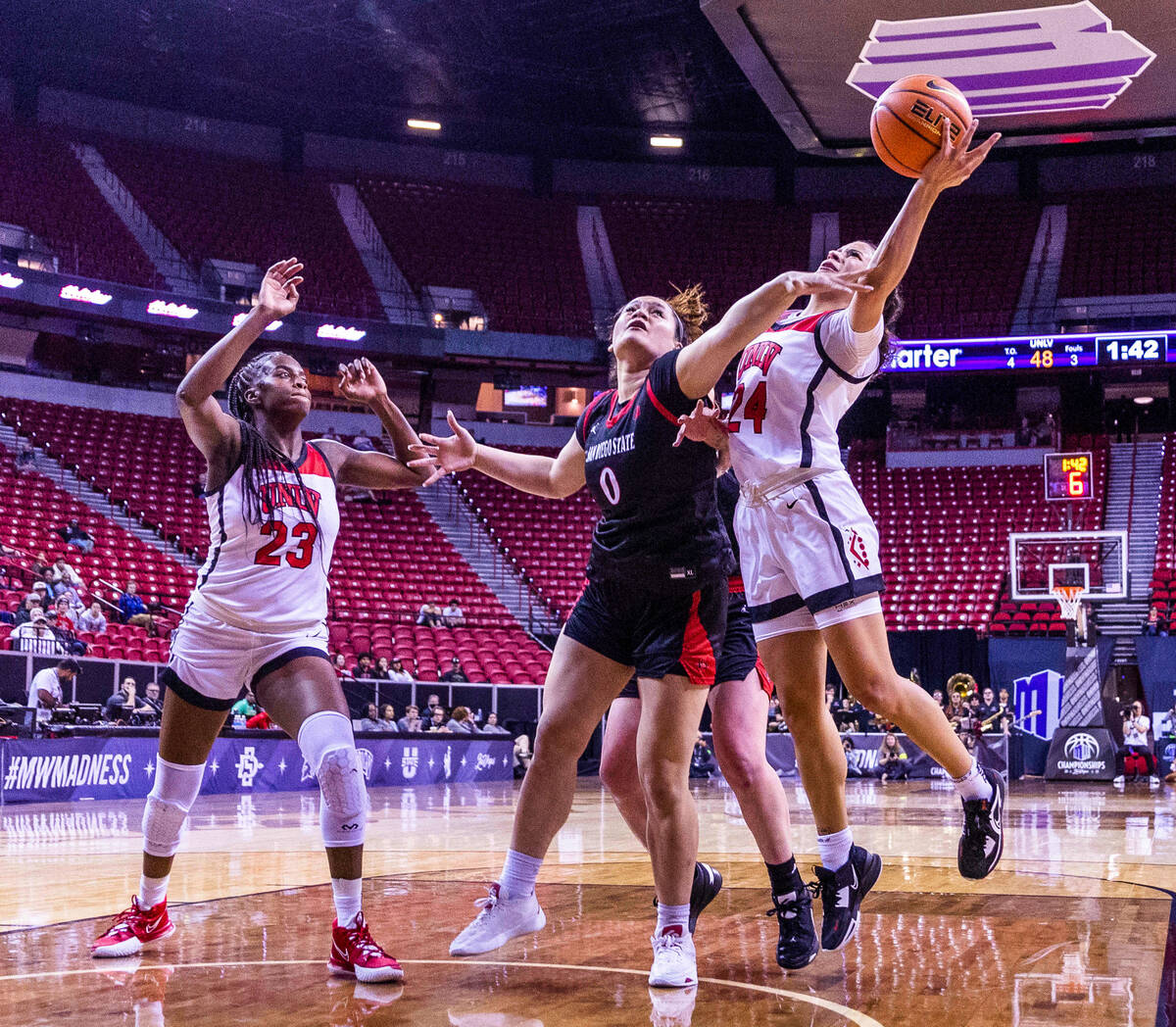 UNLV guard Essence Booker (24) gets around San Diego State guard Khylee Pepe (0) for a shot wit ...