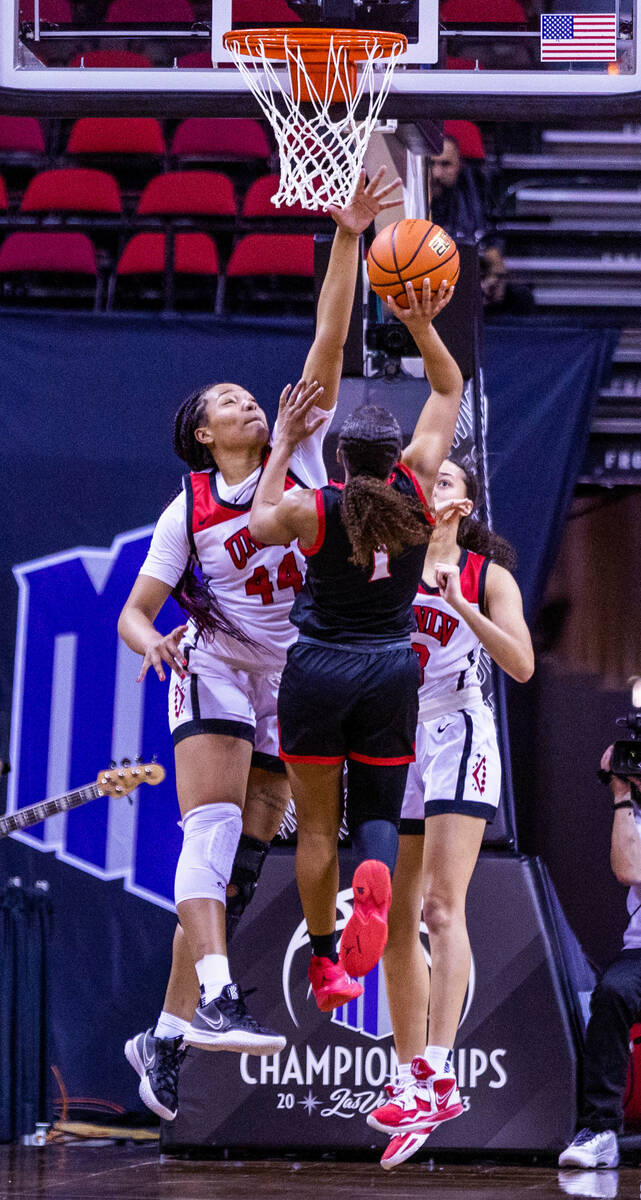 UNLV forward Alyssa Brown (44) rejects a shot attempt by San Diego State guard Asia Avinger (1) ...
