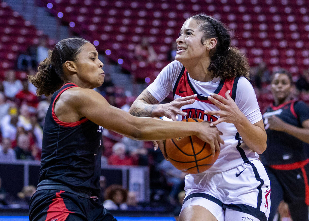 San Diego State guard Asia Avinger (1) strips the ball from UNLV guard Essence Booker (24) as s ...