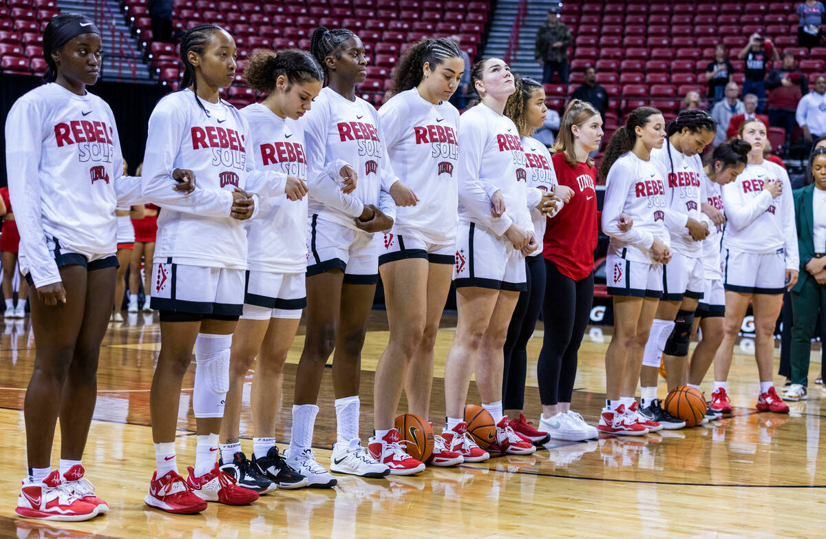 UNLV players stand united for the National Anther before facing San Diego State during the firs ...