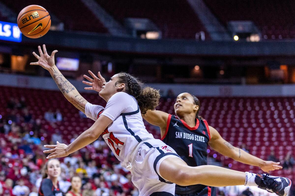 UNLV guard Essence Booker (24) gets inside of San Diego State guard Asia Avinger (1) for a bask ...