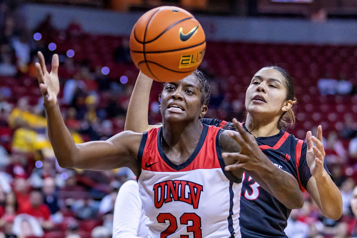 UNLV center Desi-Rae Young (23) looks to grab a loose ball with San Diego State forward Kim Vil ...
