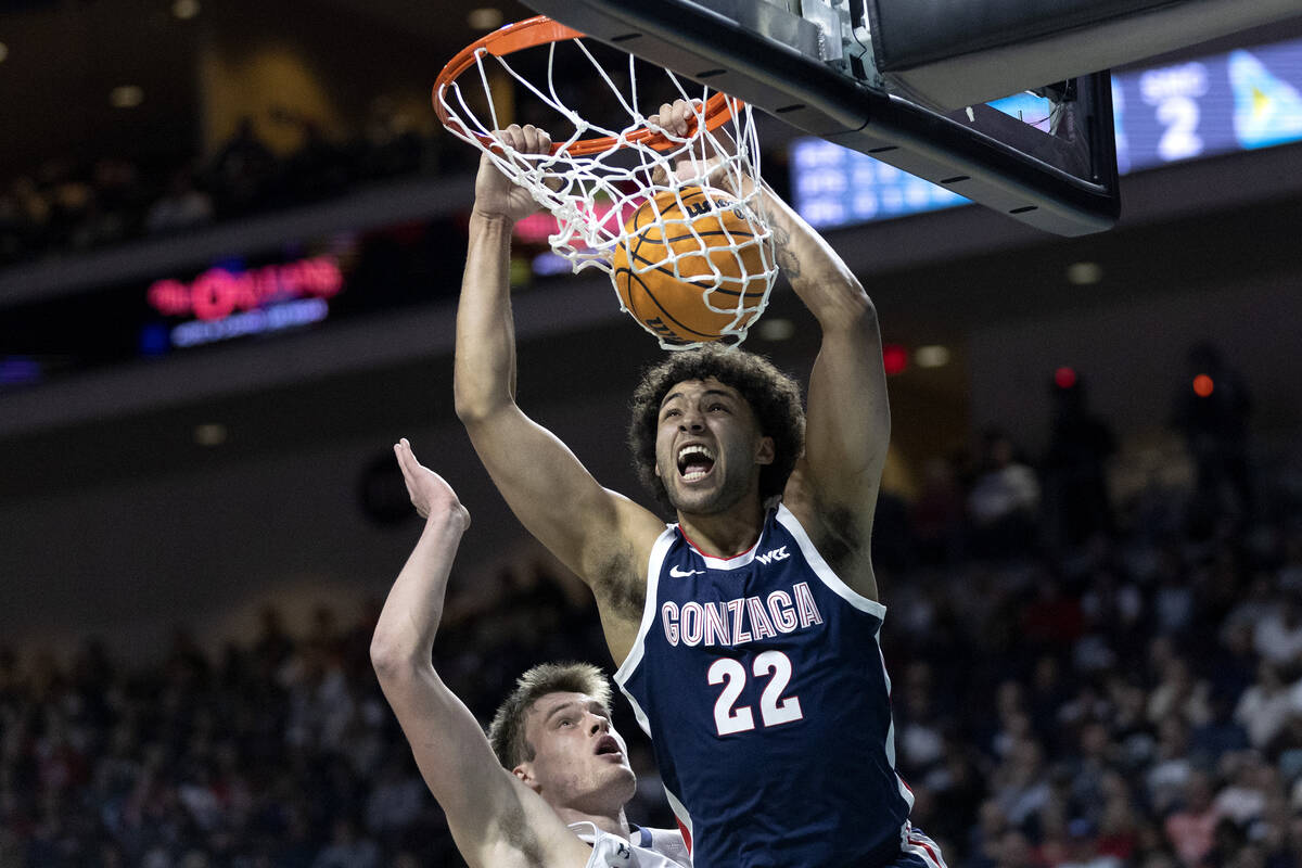 Gonzaga Bulldogs forward Anton Watson (22) dunks against St. Mary's Gaels center Mitchell Saxen ...