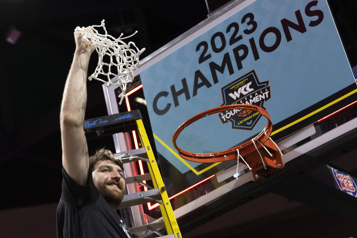 Gonzaga Bulldogs forward Drew Timme holds up the net after the Bulldogs won a West Coast Confer ...
