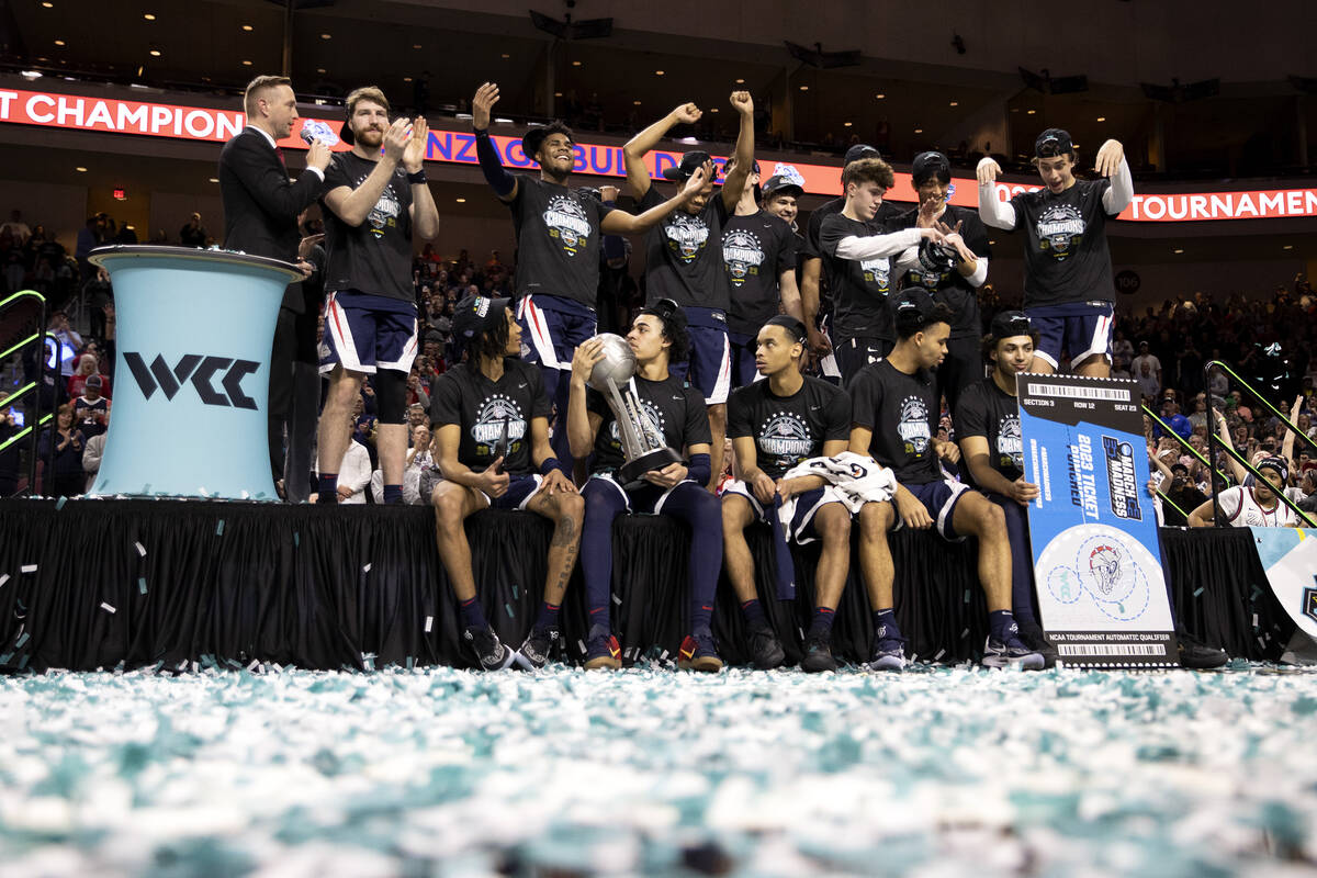 The Gonzaga Bulldogs cheer and pose for photos after winning a West Coast Conference men’ ...