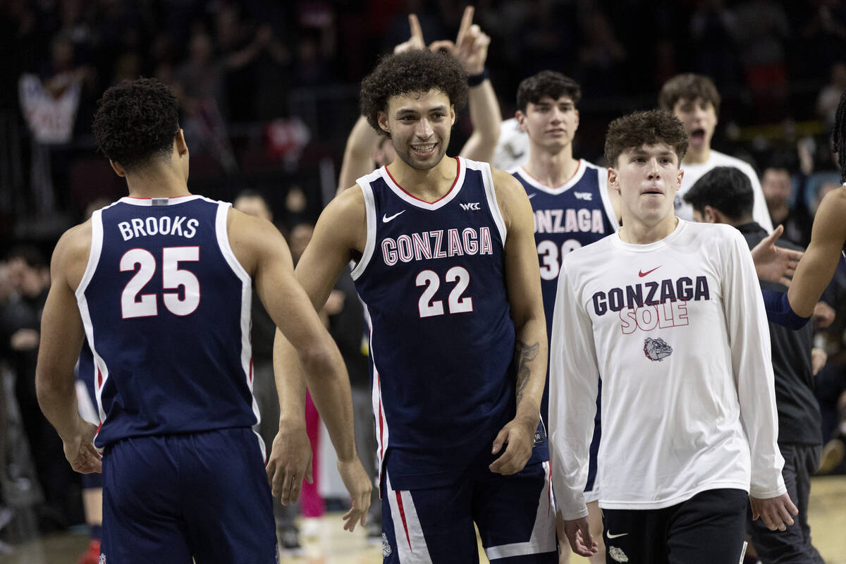 Gonzaga Bulldogs forward Anton Watson (22) slaps hands with forward Colby Brooks (25) after the ...