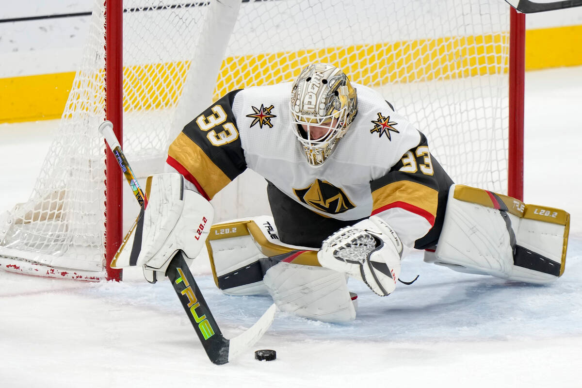 Vegas Golden Knights goaltender Adin Hill dives on the puck during the third period of an NHL h ...