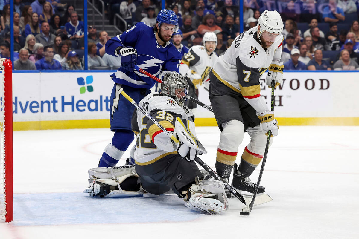 Vegas Golden Knights' Alex Pietrangelo (7) clears a rebound in front of goaltender Jonathan Qui ...