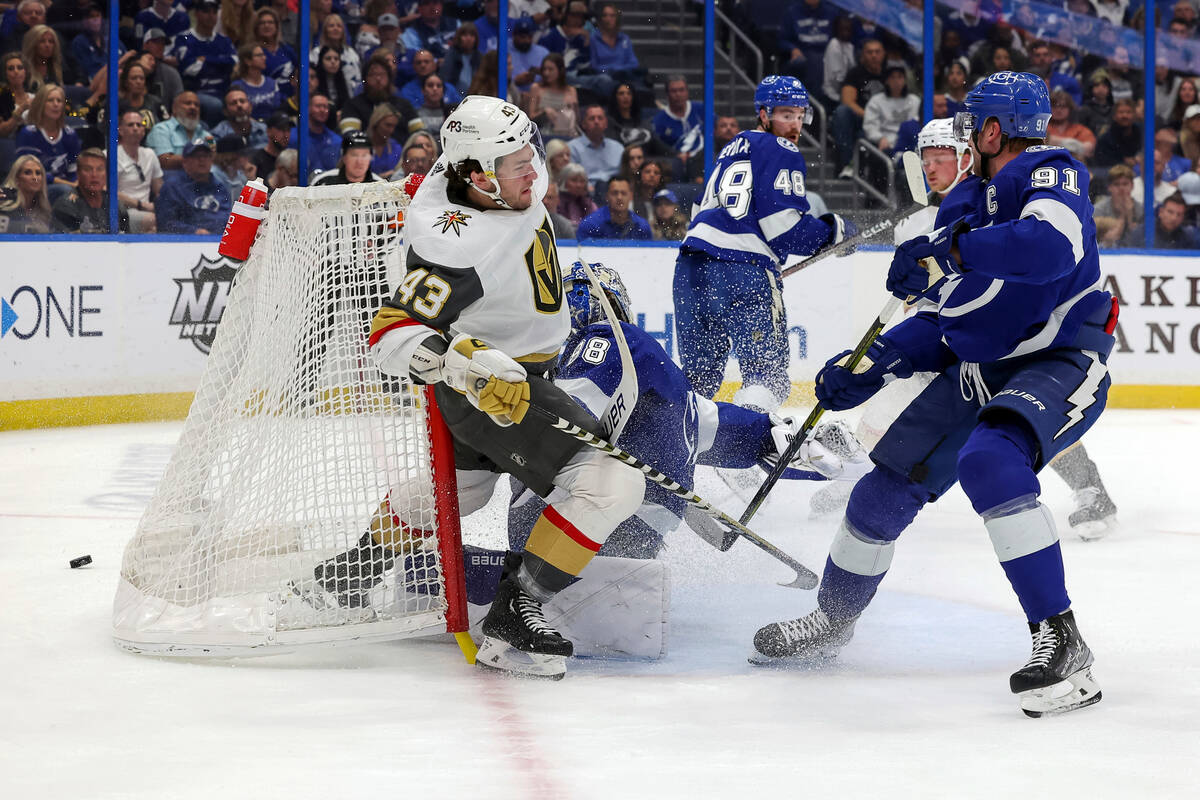 Vegas Golden Knights' Paul Cotter (43) crashes into Tampa Bay Lightning goaltender Andrei Vasil ...