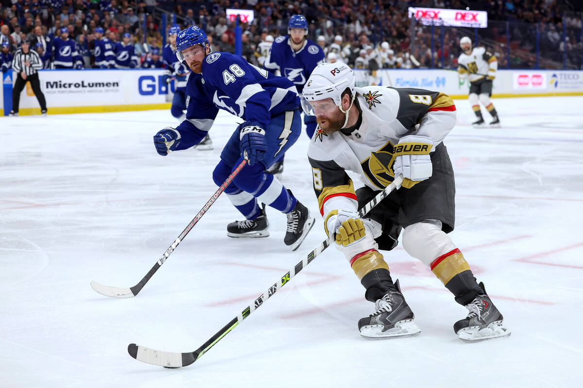 Vegas Golden Knights' Phil Kessel (8) avoids the defense of Tampa Bay Lightning's Nick Perbix d ...