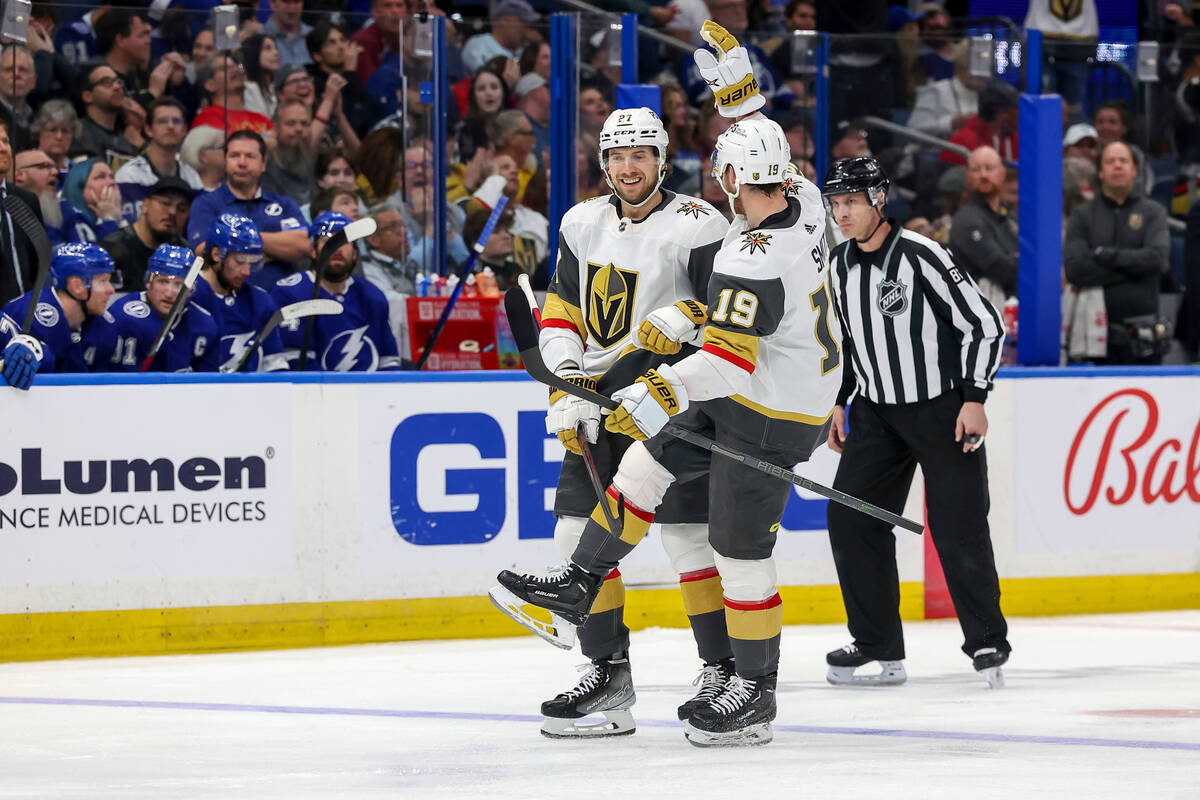 Vegas Golden Knights' Shea Theodore, left, celebrates a goal against the Tampa Bay Lightning wi ...