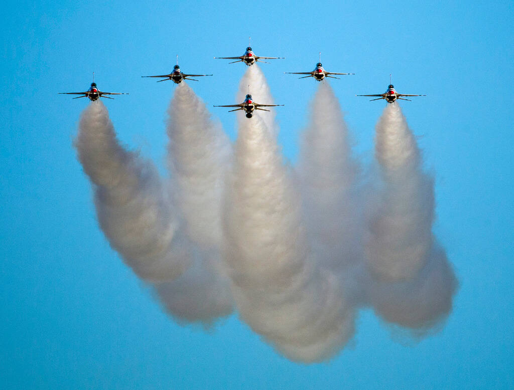 All six U.S. Air Force Thunderbirds prepare to break away from formation in various directions ...