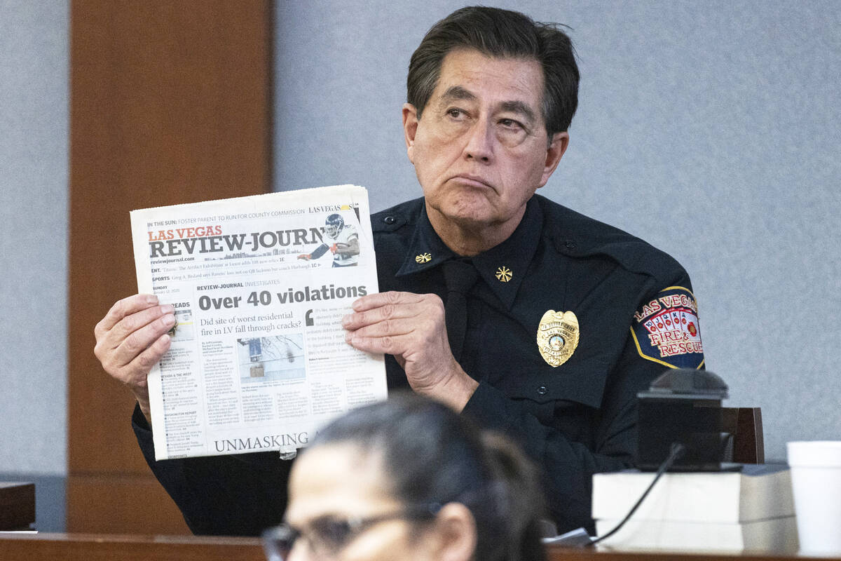 Las Vegas Fire Marshal Robert Nolan, holds a copy of the Las Vegas Review-Journal as he deliver ...