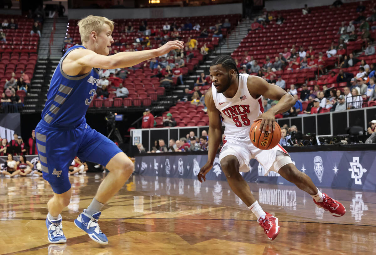 UNLV guard EJ Harkless (55) drives the ball under pressure from Air Force forward Rytis Petrait ...