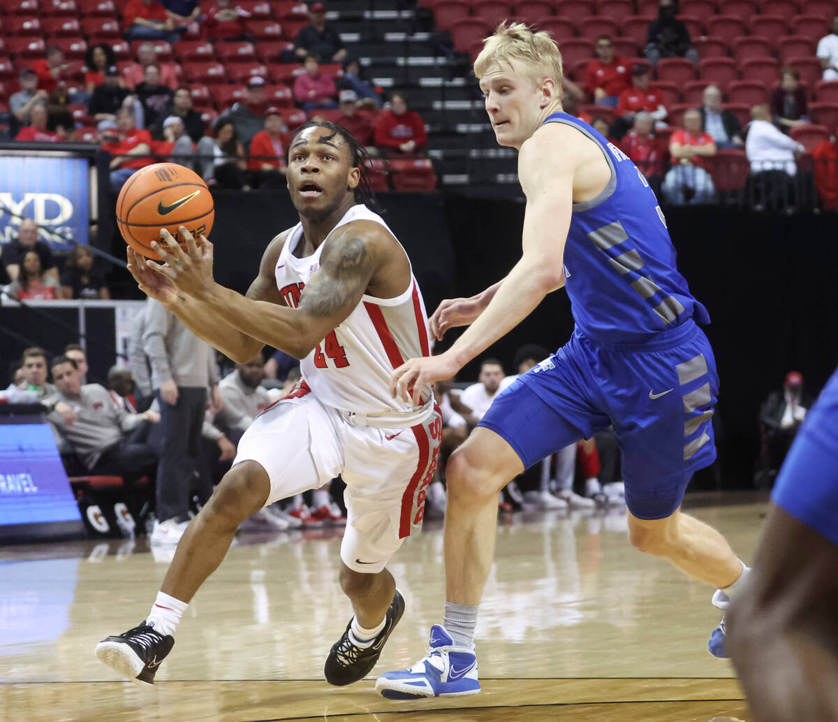 UNLV guard Jackie Johnson III (24) drives to the basket against Air Force forward Rytis Petrait ...