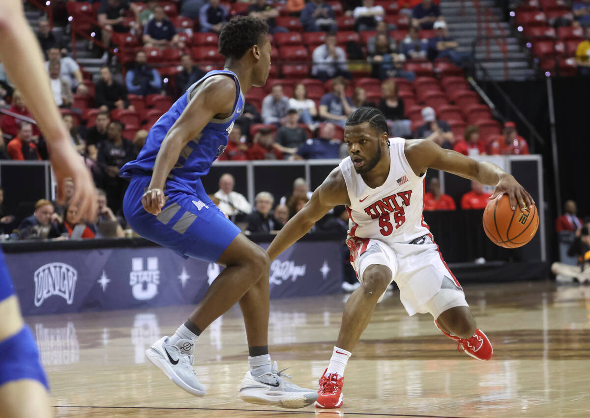 UNLV guard EJ Harkless (55) drives the ball against Air Force guard Ethan Taylor (5) during the ...