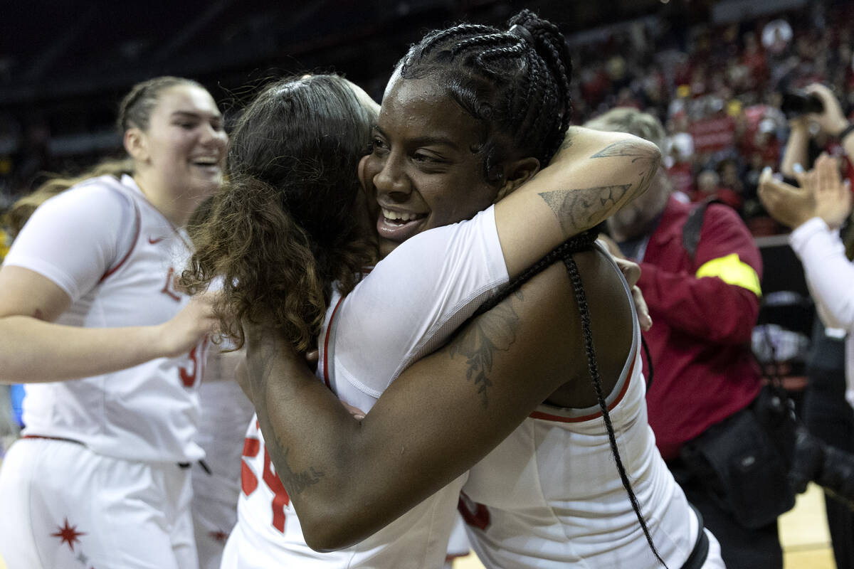 UNLV Lady Rebels center Desi-Rae Young, right, hugs guard Essence Booker after they lead their ...