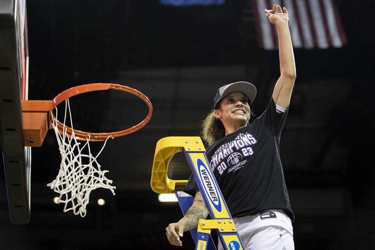 UNLV Lady Rebels guard Essence Booker holds up her piece of net after the Lady Rebels won the M ...