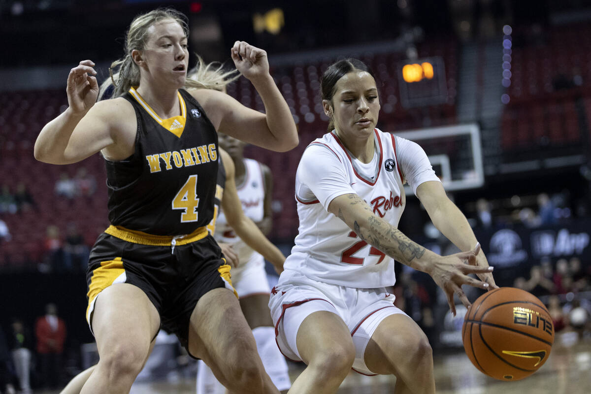 UNLV Lady Rebels guard Essence Booker (24) dribbles while Wyoming Cowgirls forward Grace Ellis ...