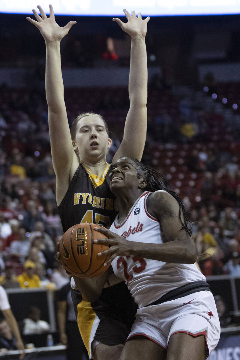 UNLV Lady Rebels center Desi-Rae Young (23) shoots against Wyoming Cowgirls center Allyson Fert ...