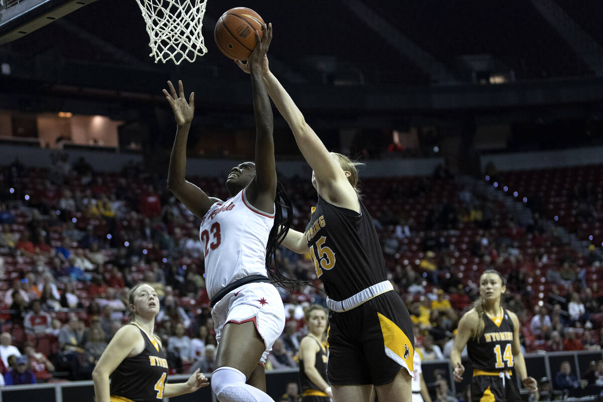 UNLV Lady Rebels center Desi-Rae Young (23) shoots against Wyoming Cowgirls center Allyson Fert ...