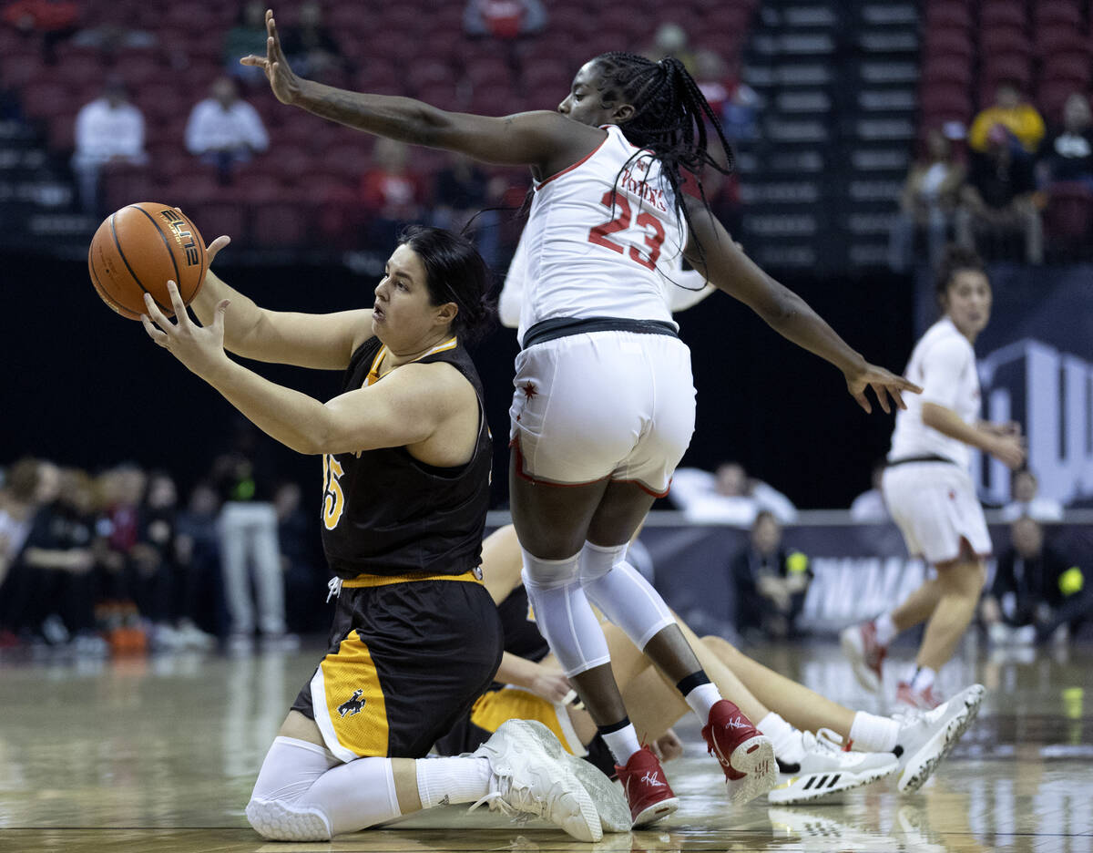 Wyoming Cowgirls forward Marta Savic (15) and UNLV Lady Rebels center Desi-Rae Young (23) compe ...