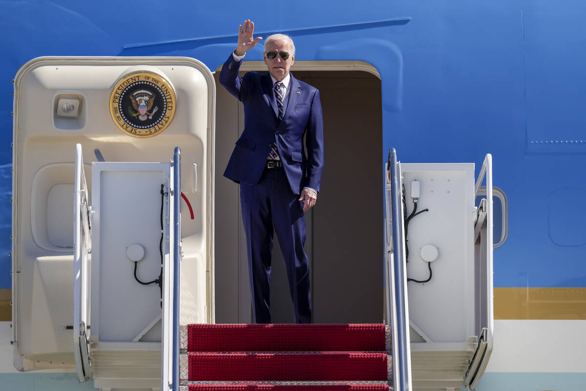 President Joe Biden waves as he boards Air Force One at Andrews Air Force Base, Md., Thursday, ...