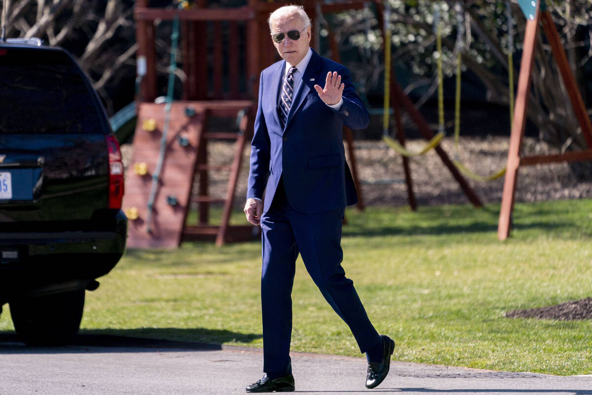 President Joe Biden waves as he walks towards Marine One on the South Lawn of the White House i ...