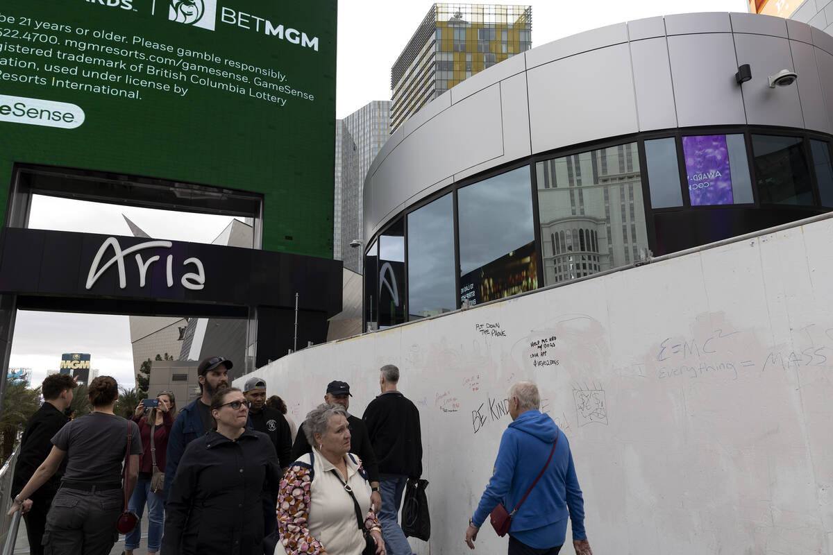 Pedestrians pass construction for 63, a new retail complex at the intersection of Las Vegas Bou ...