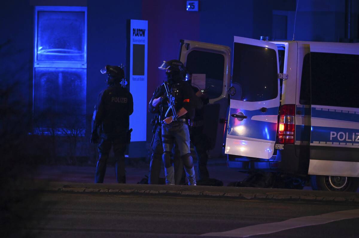 Armed police officers near the scene of a shooting in Hamburg, Germany on Thursday March 9, 202 ...