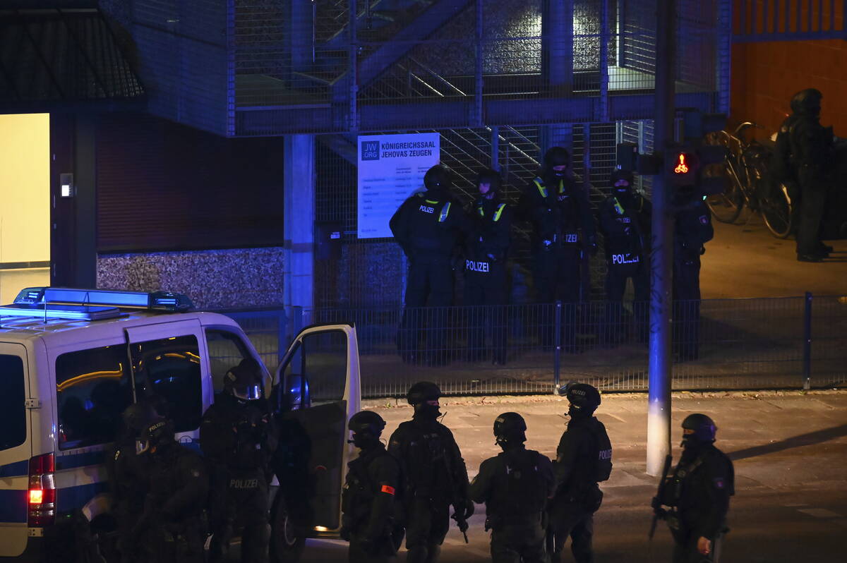 Armed police officers near the scene of a shooting in Hamburg, Germany on Thursday March 9, 202 ...