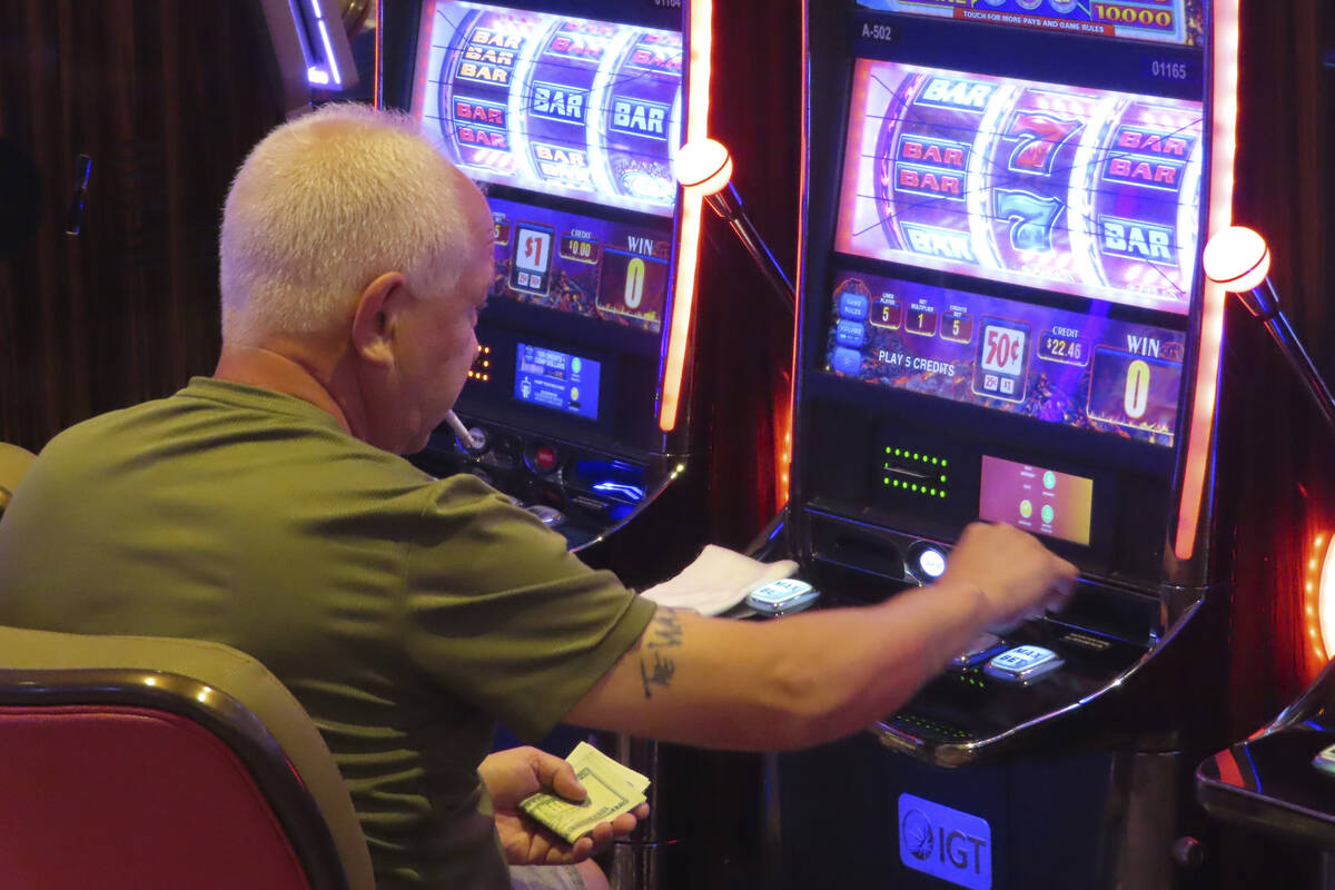 A gambler plays a slot machine while smoking in the Hard Rock casino in Atlantic City N.J. on A ...