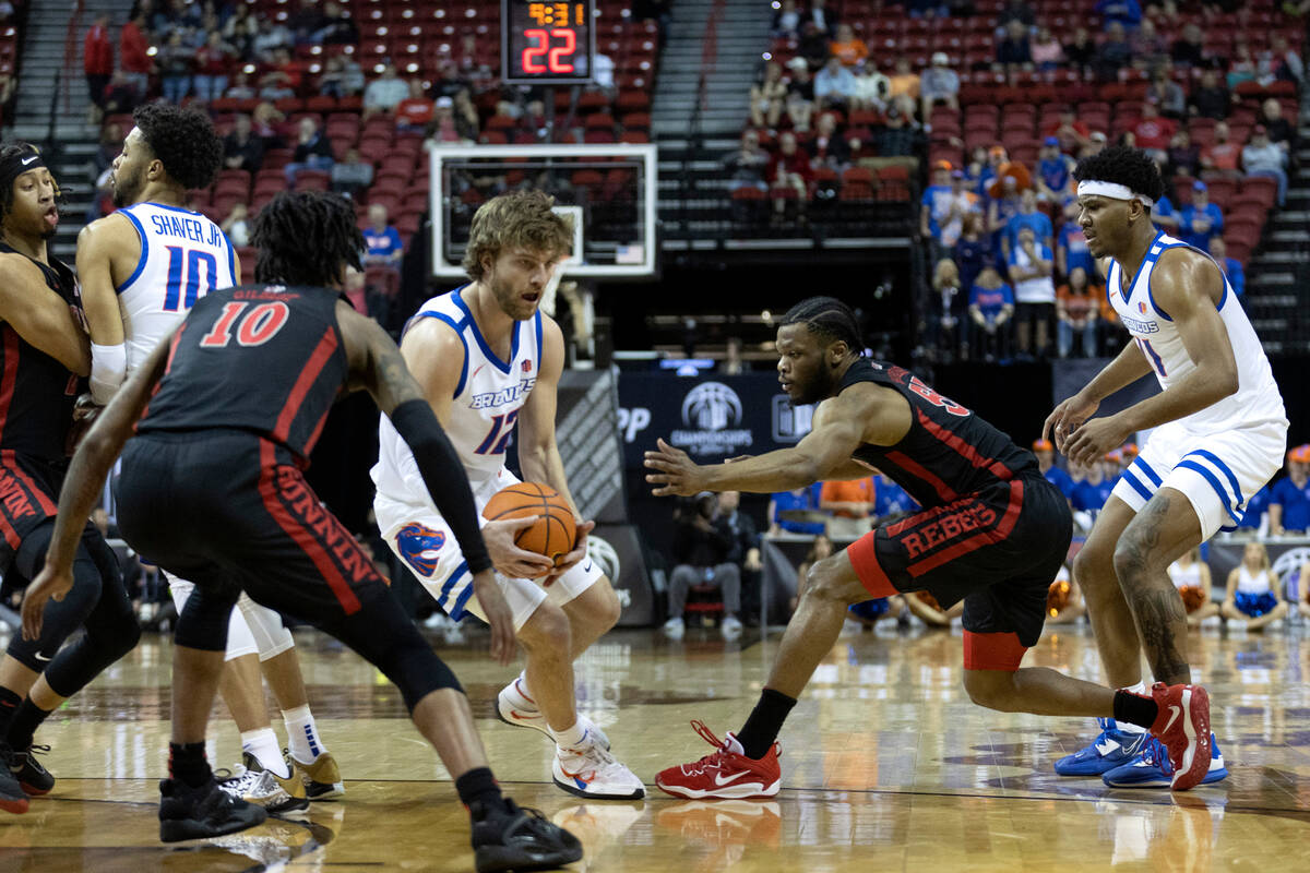 UNLV Rebels guard EJ Harkless (55) attempts to steal possession from Boise State Broncos guard ...