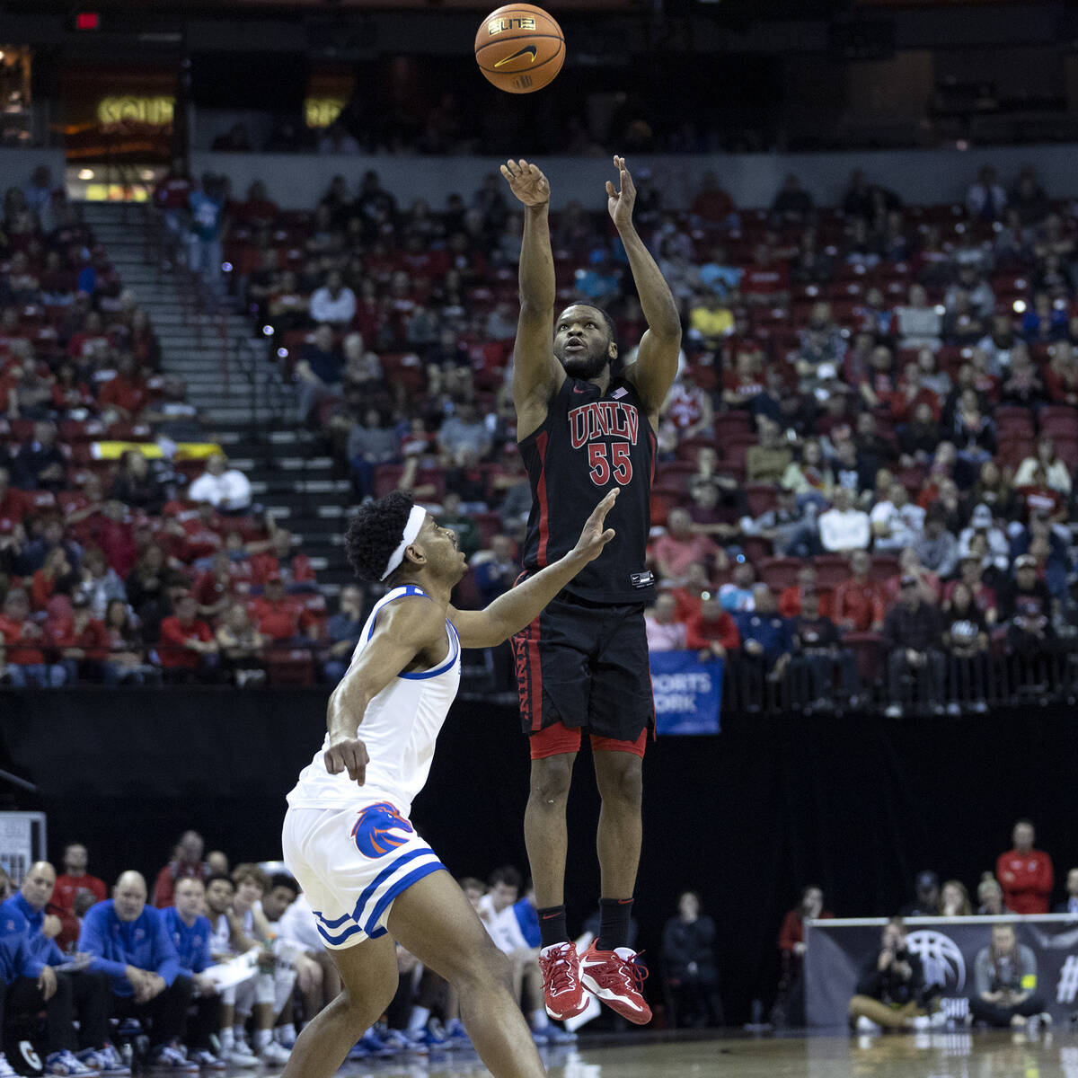UNLV Rebels guard EJ Harkless (55) shoots against Boise State Broncos guard Chibuzo Agbo, left, ...