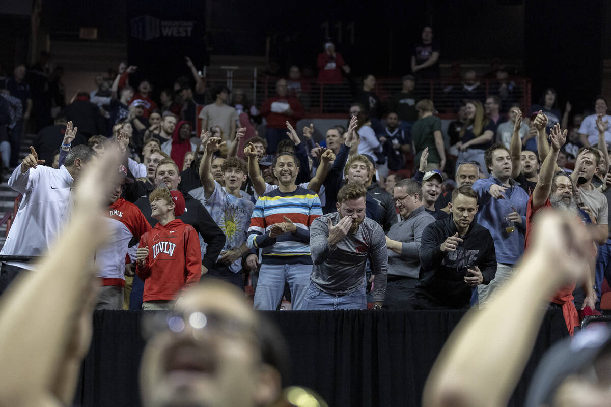 UNLV Rebels fans cheer for their team during overtime in an NCAA college basketball quarterfina ...